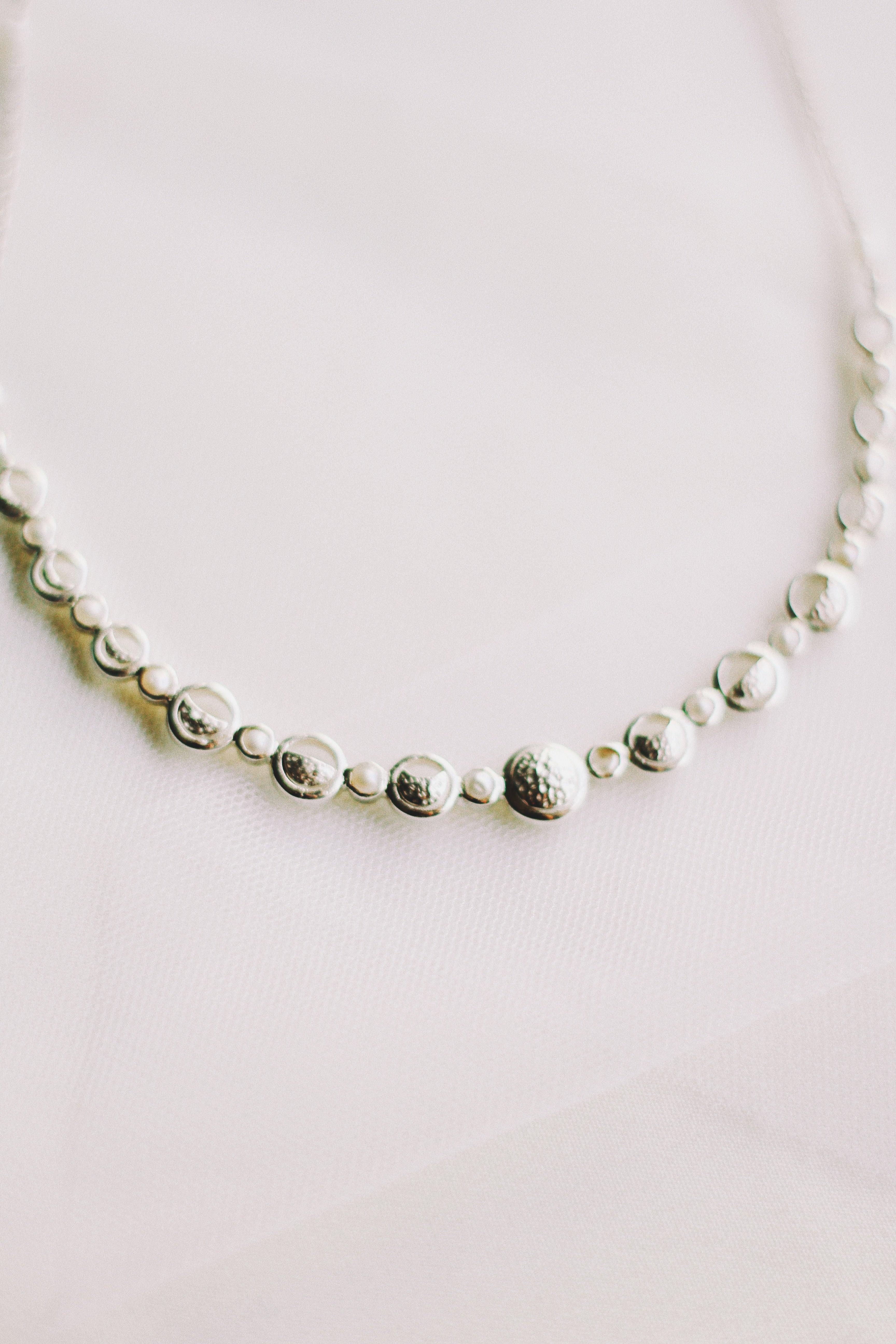 Lunar Cycle Beaten Silver Arc Necklace